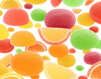 Image of Sweet jelly candies flying against white background