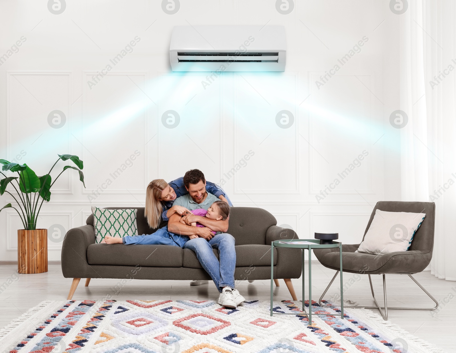 Image of Happy family having fun together at home. Air conditioner keeping comfortable temperature in room