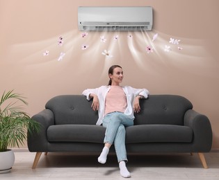 Image of Smiling woman relaxing on sofa at home. Air conditioner keeping comfortable temperature in room