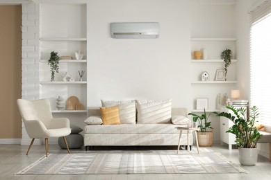 Image of Contemporary furniture, houseplants and decor in living room. Air conditioner keeping comfortable temperature indoors