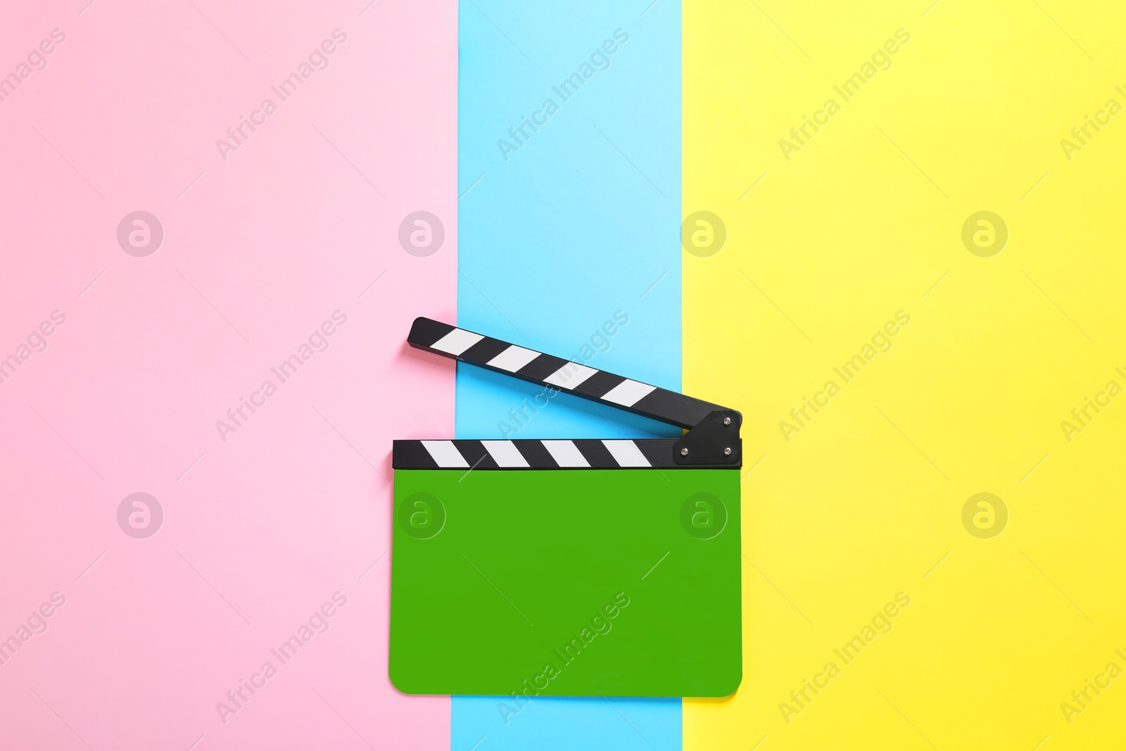 Image of Green clapperboard on color background, top view. Film industry
