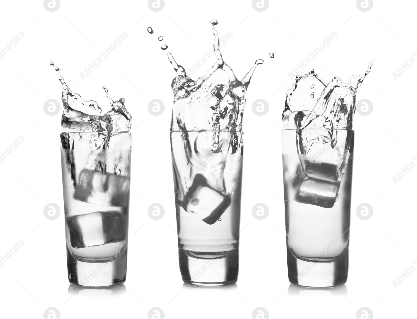 Image of Vodka in shot glasses with ice cubes isolated on white, set