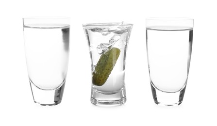 Image of Vodka in shot glasses and one with pickle inside isolated on white
