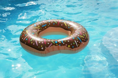 Photo of Inflatable ring floating on water in swimming pool
