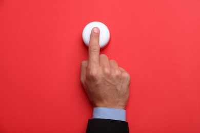 Photo of Man pressing button on red background, top view