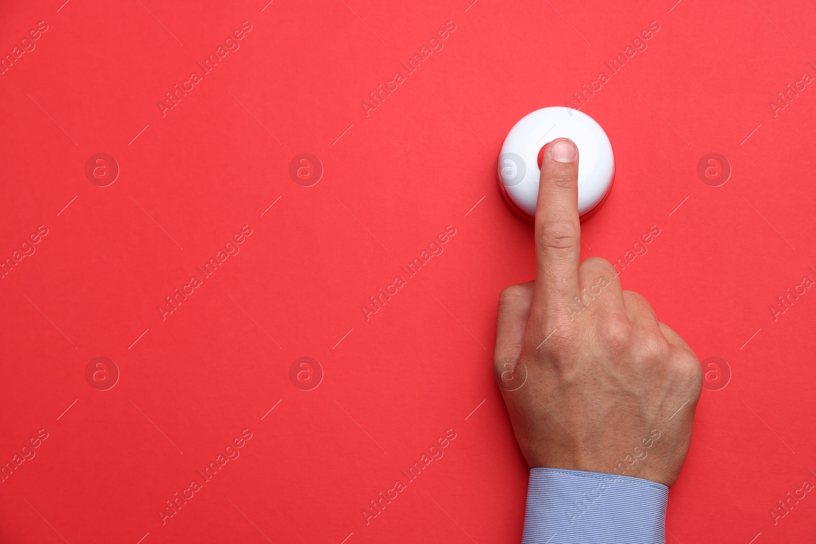 Man pressing button on red background, top view. Space for text Photo of Man pressing button on red background, top view. Space for text