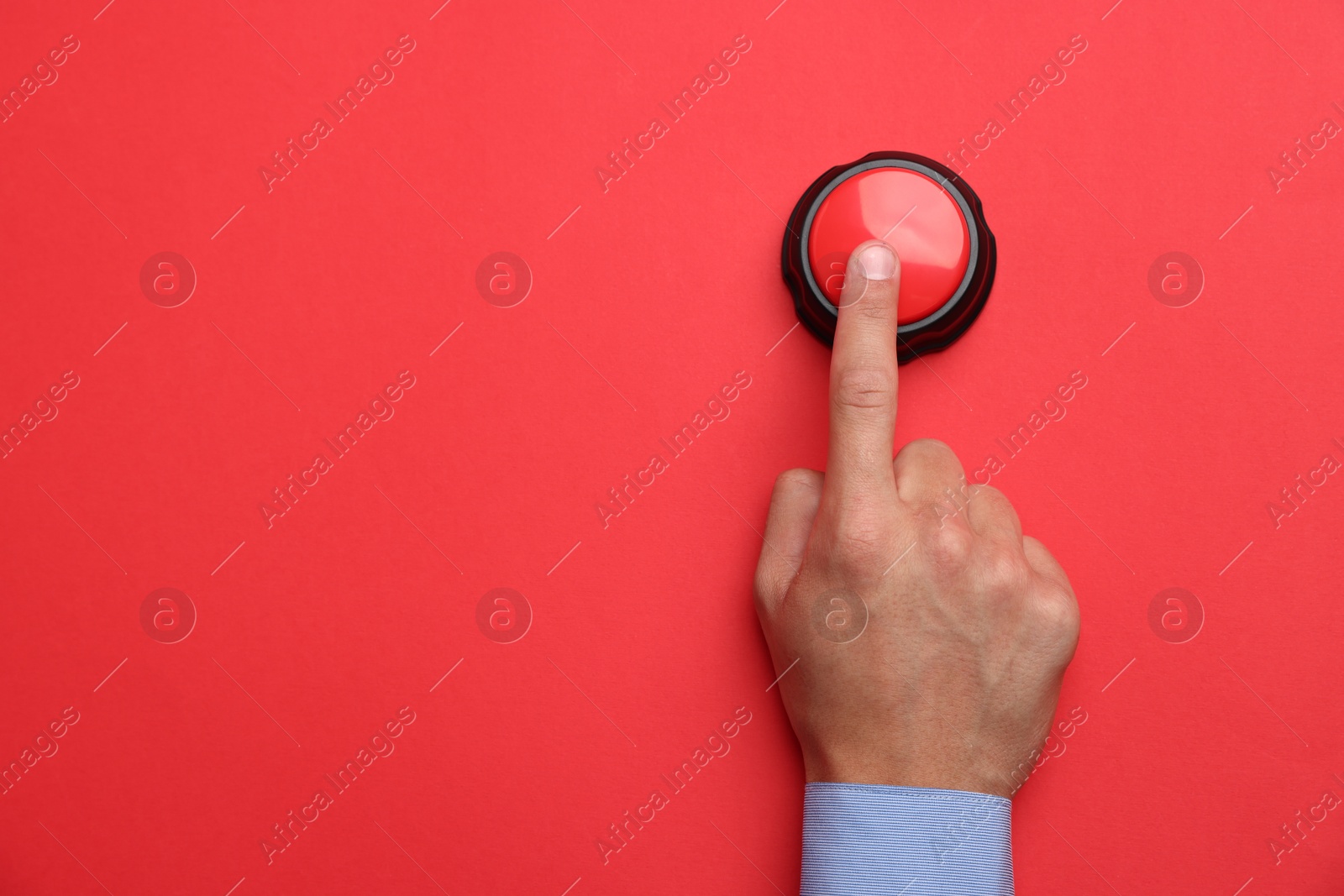 Man pressing button on red background, top view. Space for text Photo of Man pressing button on red background, top view. Space for text