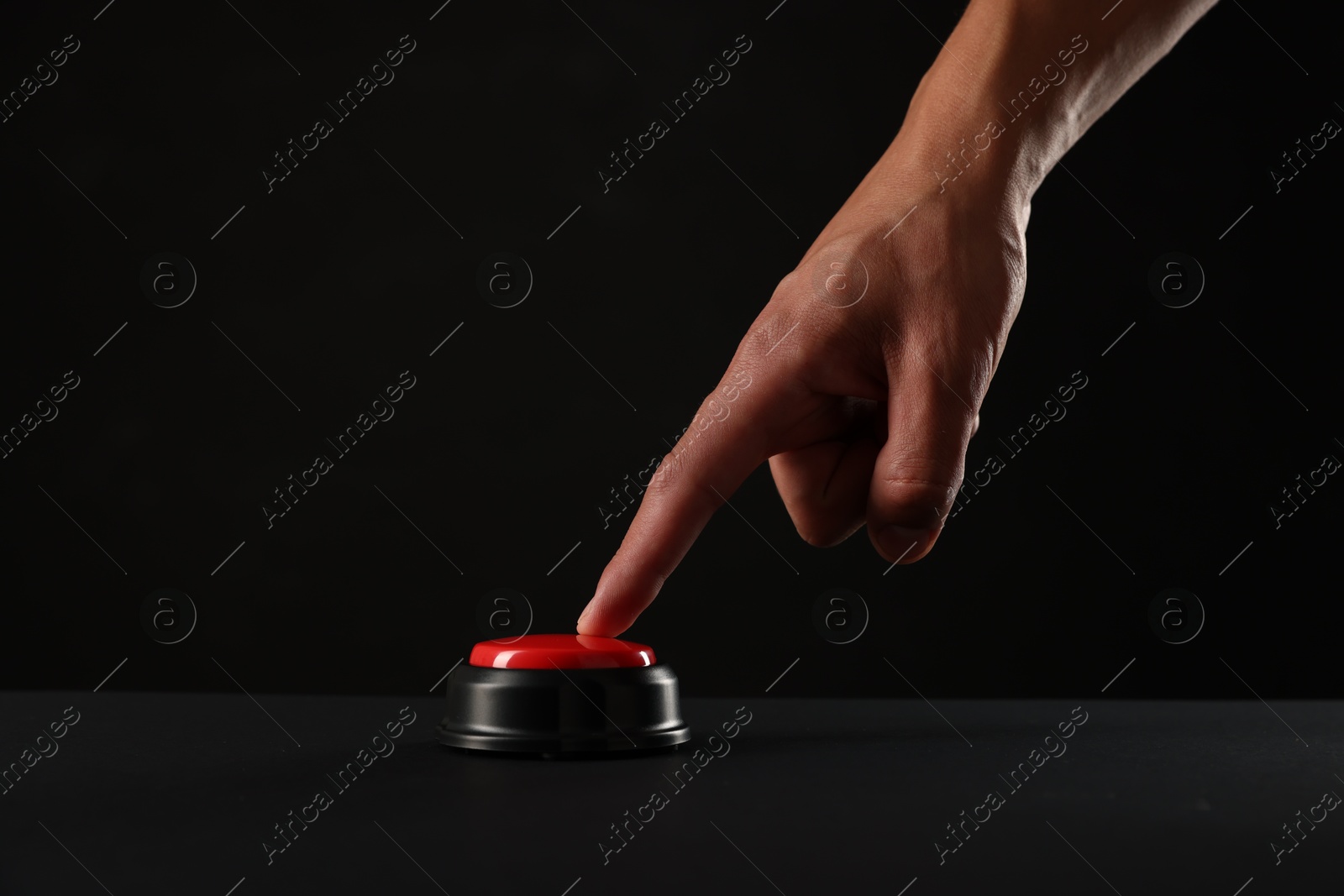 Photo of Man pressing button on black background, closeup