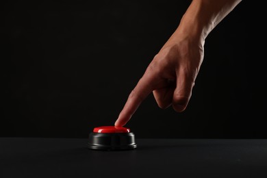Photo of Man pressing button on black background, closeup