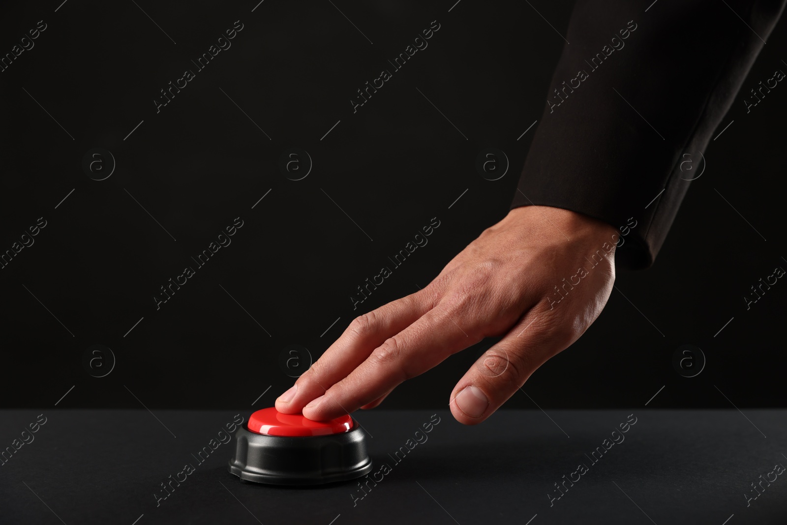 Photo of Man pressing button on black background, closeup. Space for text