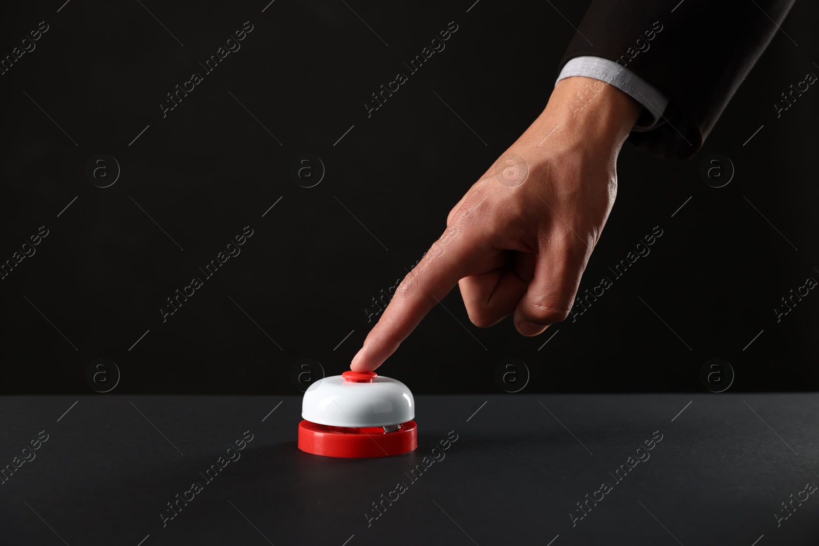 Photo of Man pressing button on black background, closeup. Space for text