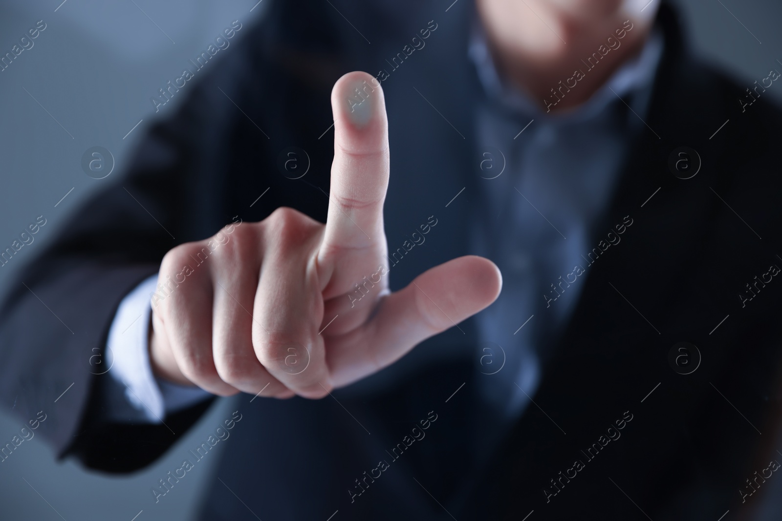 Photo of Man touching something on grey background, closeup