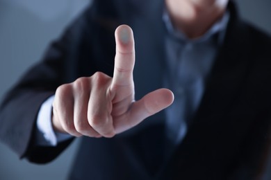 Photo of Man touching something on grey background, closeup