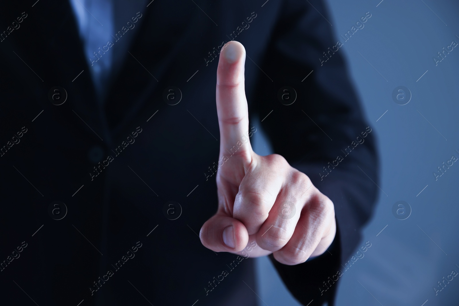 Photo of Man touching something on grey background, closeup