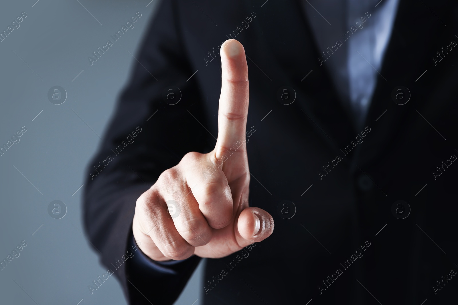 Photo of Man touching something on grey background, closeup