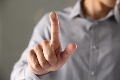 Photo of Man touching something on grey background, closeup