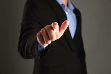 Photo of Man touching something on grey background, closeup