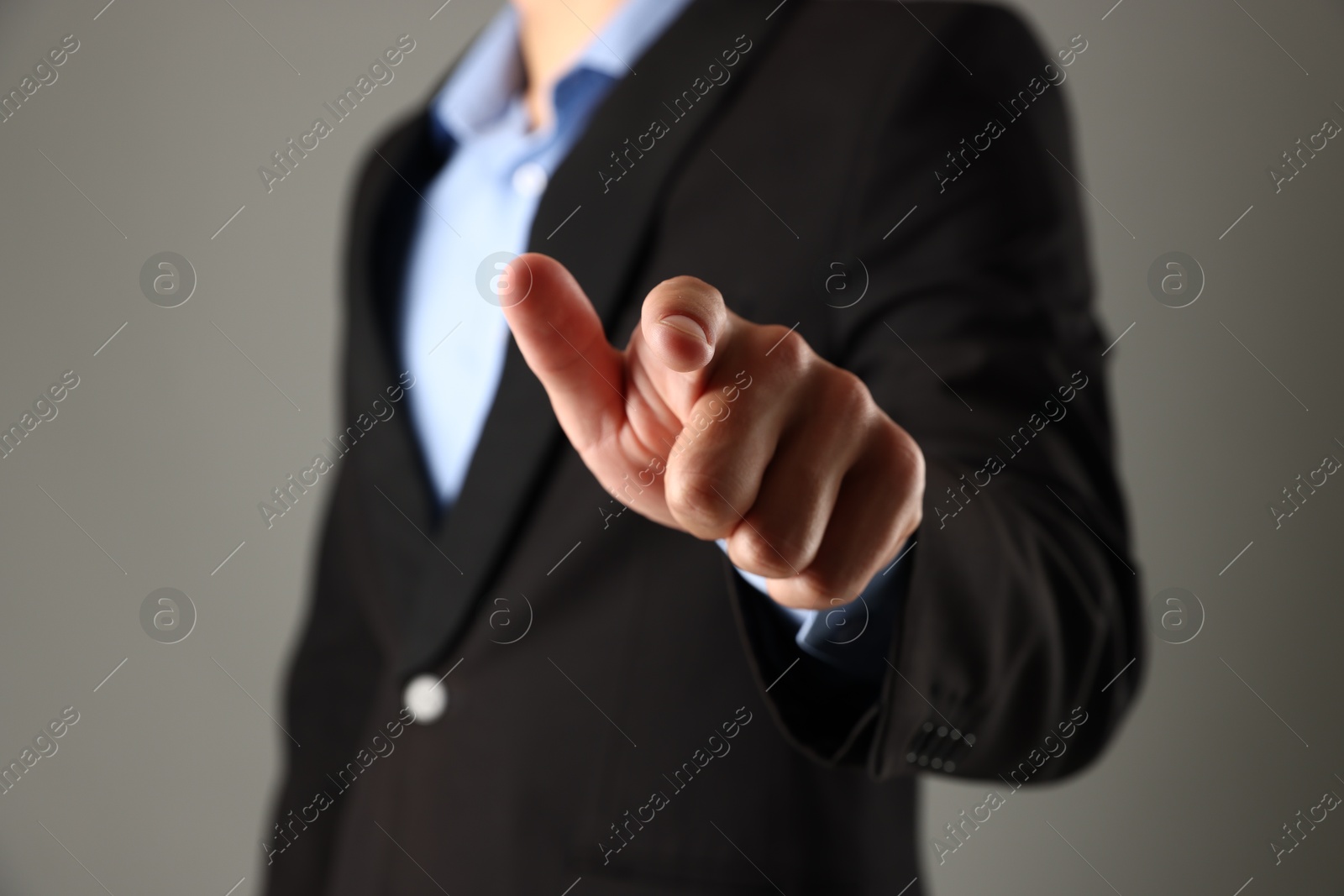 Photo of Man touching something on grey background, closeup