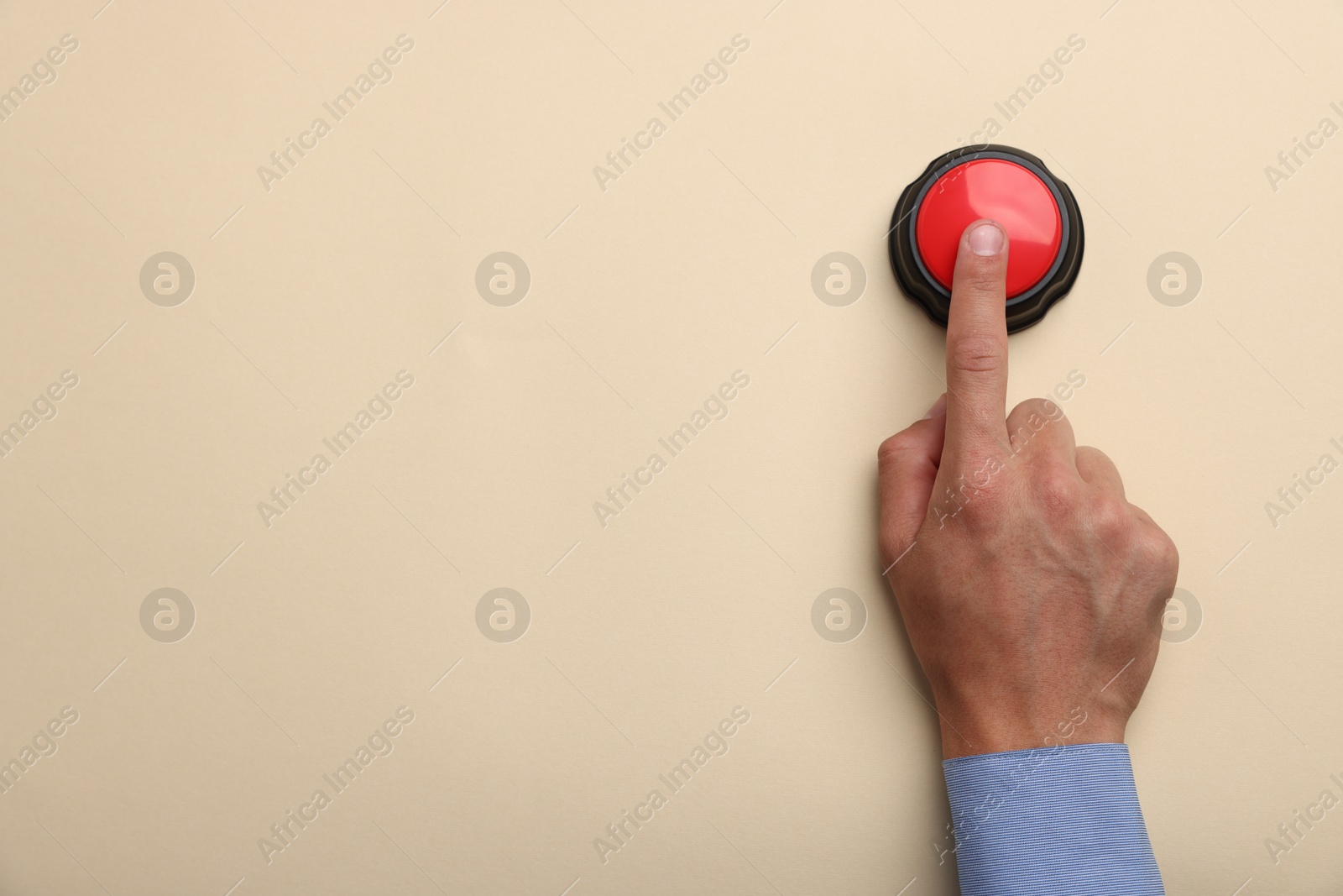 Man pressing button on beige background, top view. Space for text Photo of Man pressing button on beige background, top view. Space for text