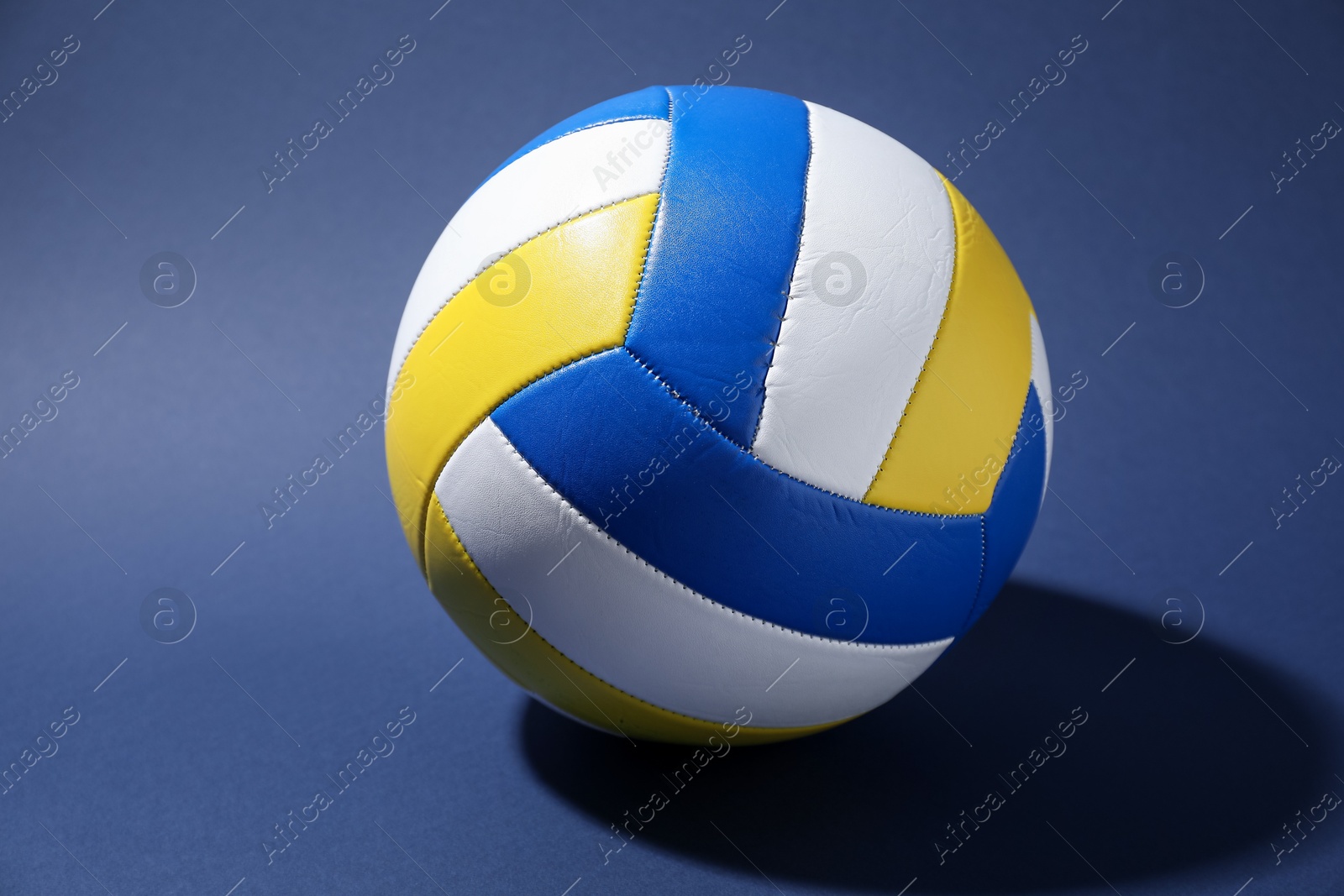 Photo of One colorful volleyball ball on blue background