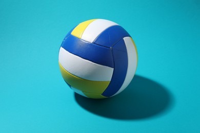 Photo of Colorful volleyball ball on light blue background