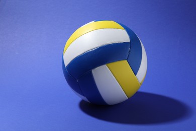 Photo of One colorful volleyball ball on blue background