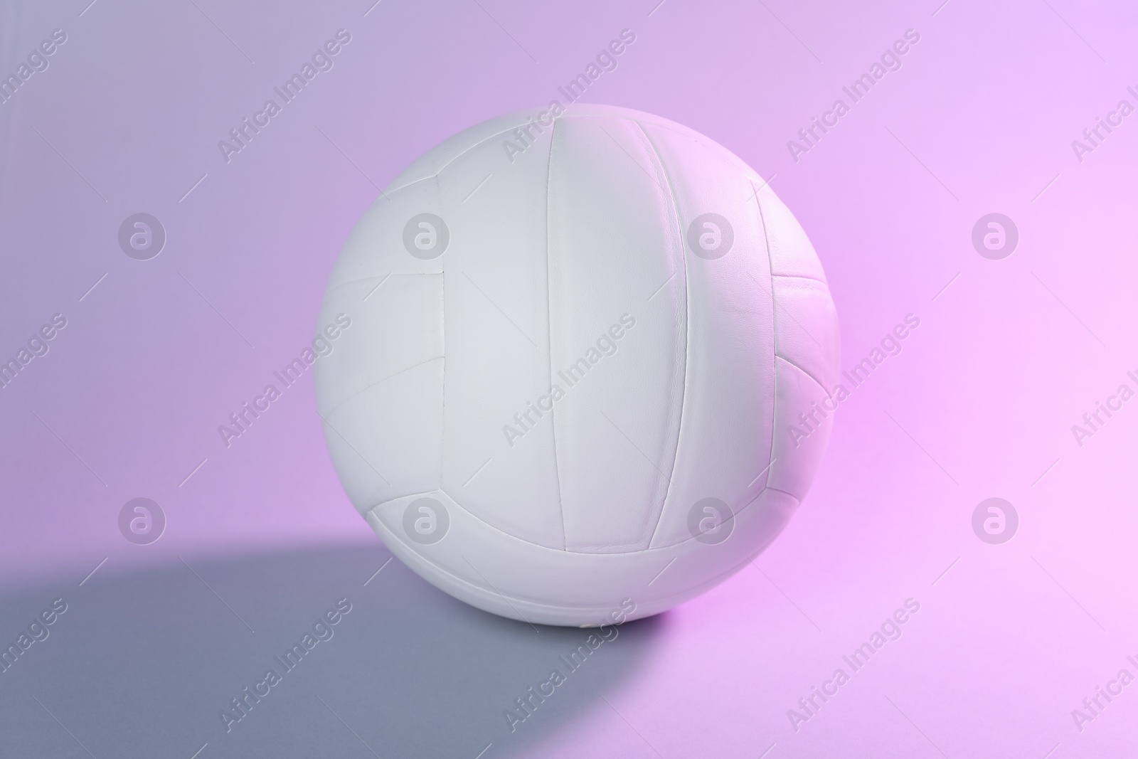Photo of One white volleyball ball on light background