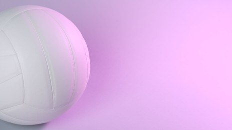 Photo of White volleyball ball on light background. Space for text