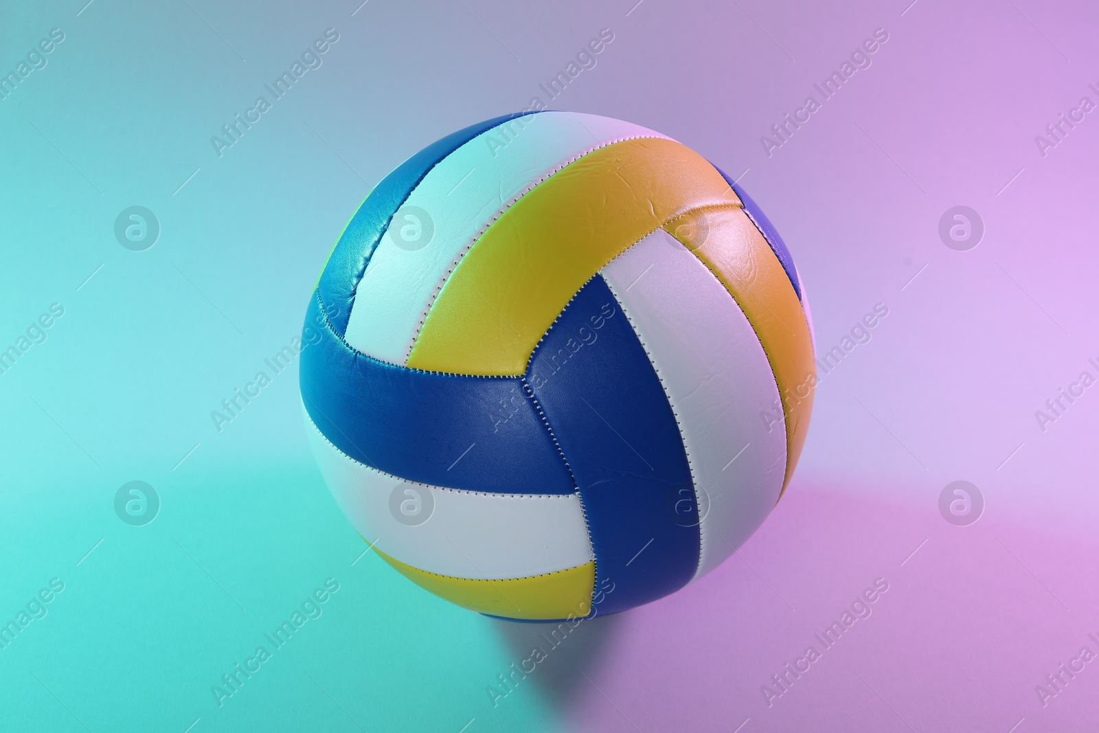 Photo of One colorful volleyball ball on color background