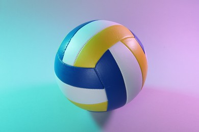 Photo of One colorful volleyball ball on color background