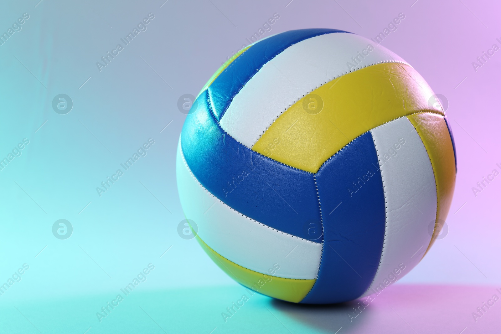 Photo of Colorful volleyball ball on color background. Space for text