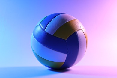 Photo of One colorful volleyball ball on color background
