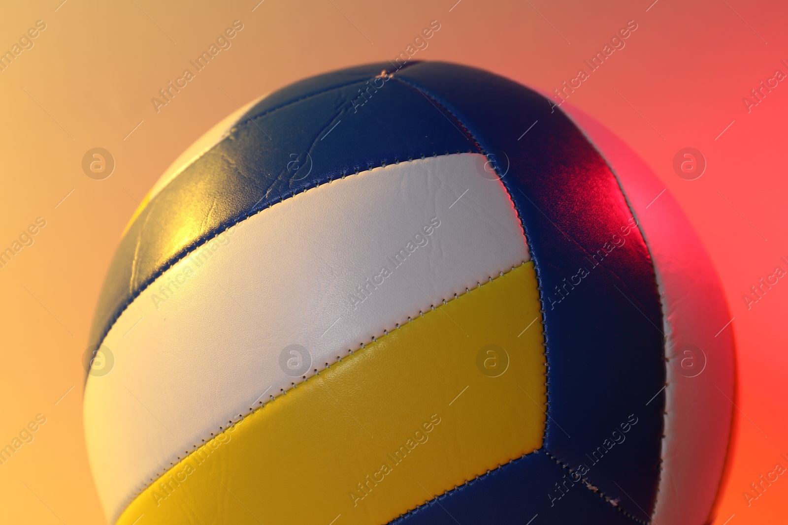 Photo of Colorful volleyball ball on color background, closeup