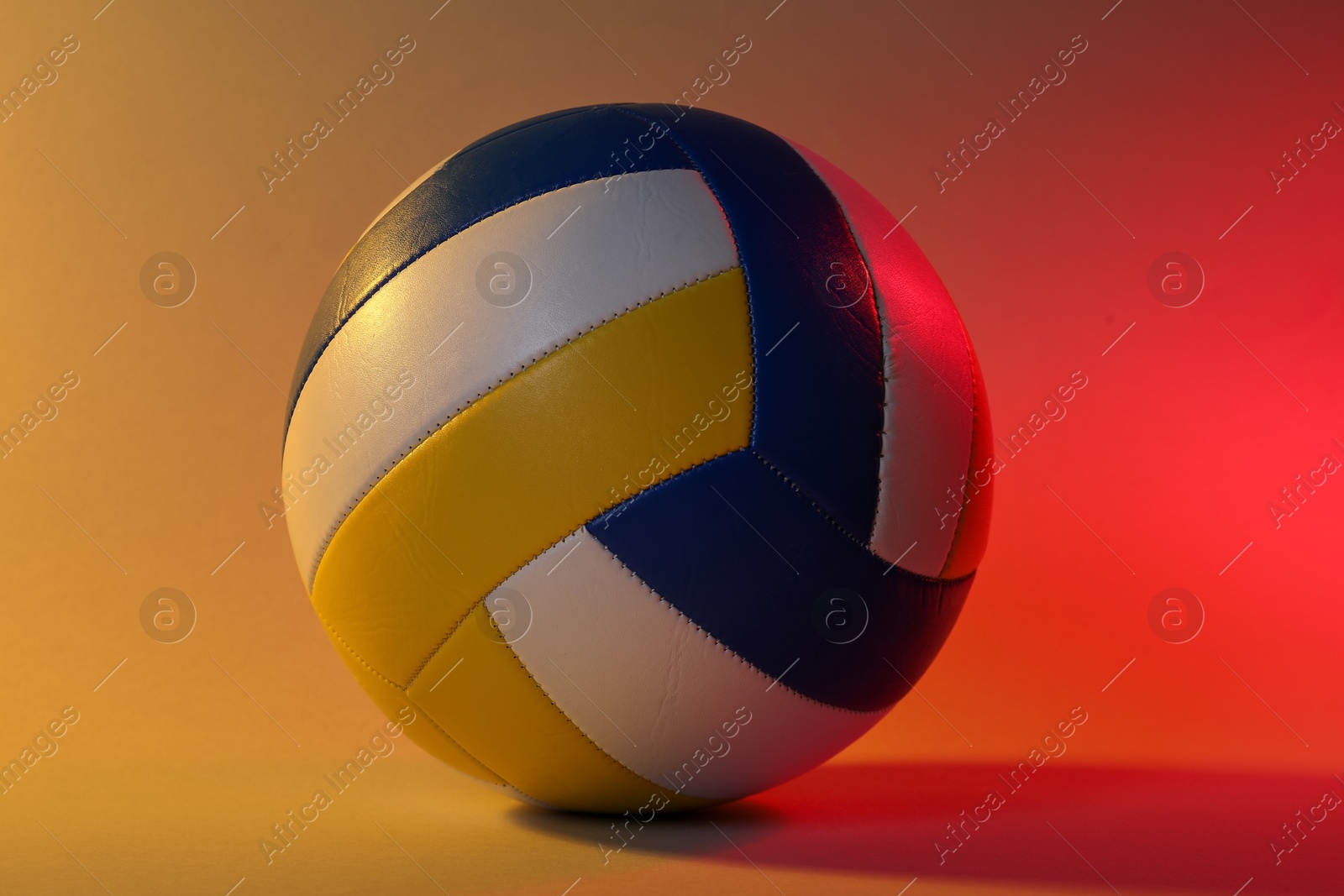 Photo of One colorful volleyball ball on color background