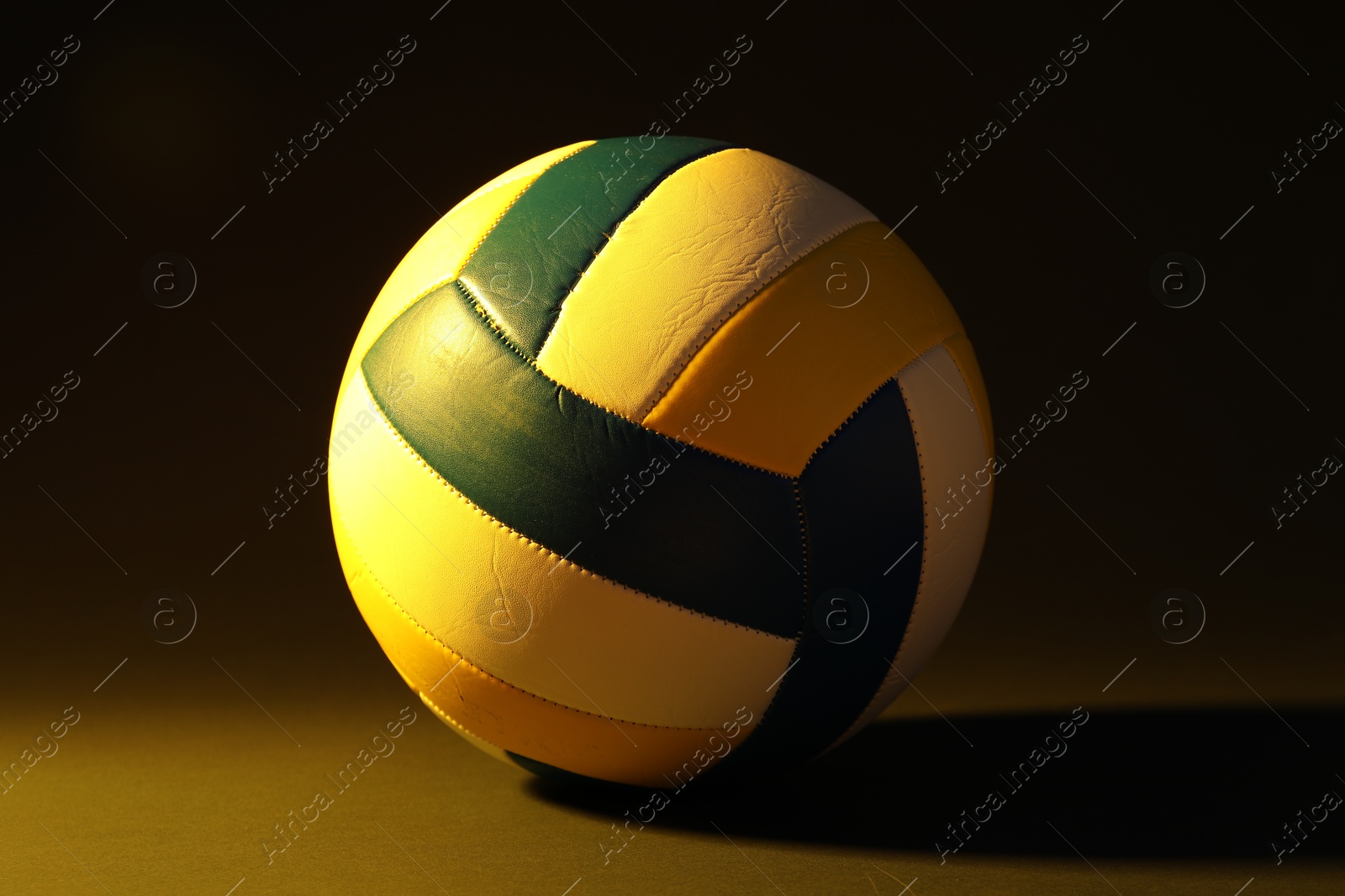 Photo of One colorful volleyball ball on dark background
