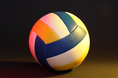 Photo of One colorful volleyball ball on color background