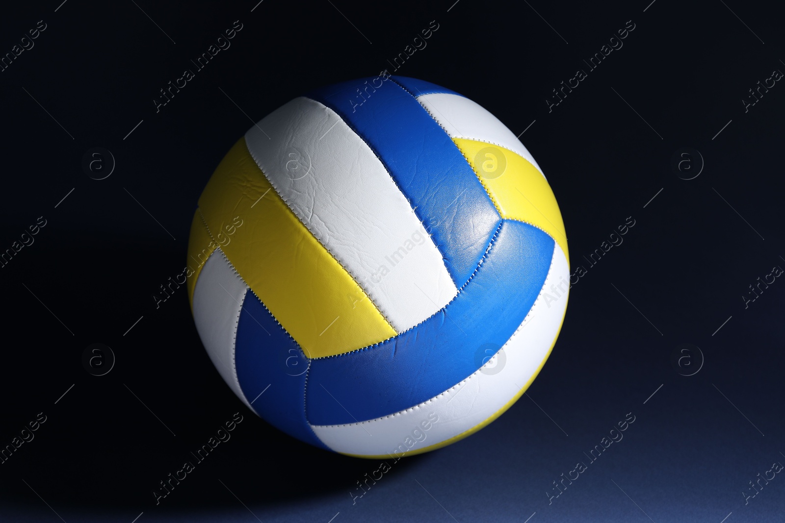 Photo of One colorful volleyball ball on dark background
