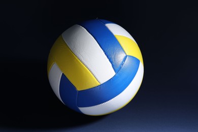 Photo of One colorful volleyball ball on dark background