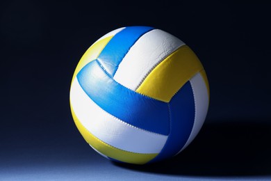 Photo of One colorful volleyball ball on dark background