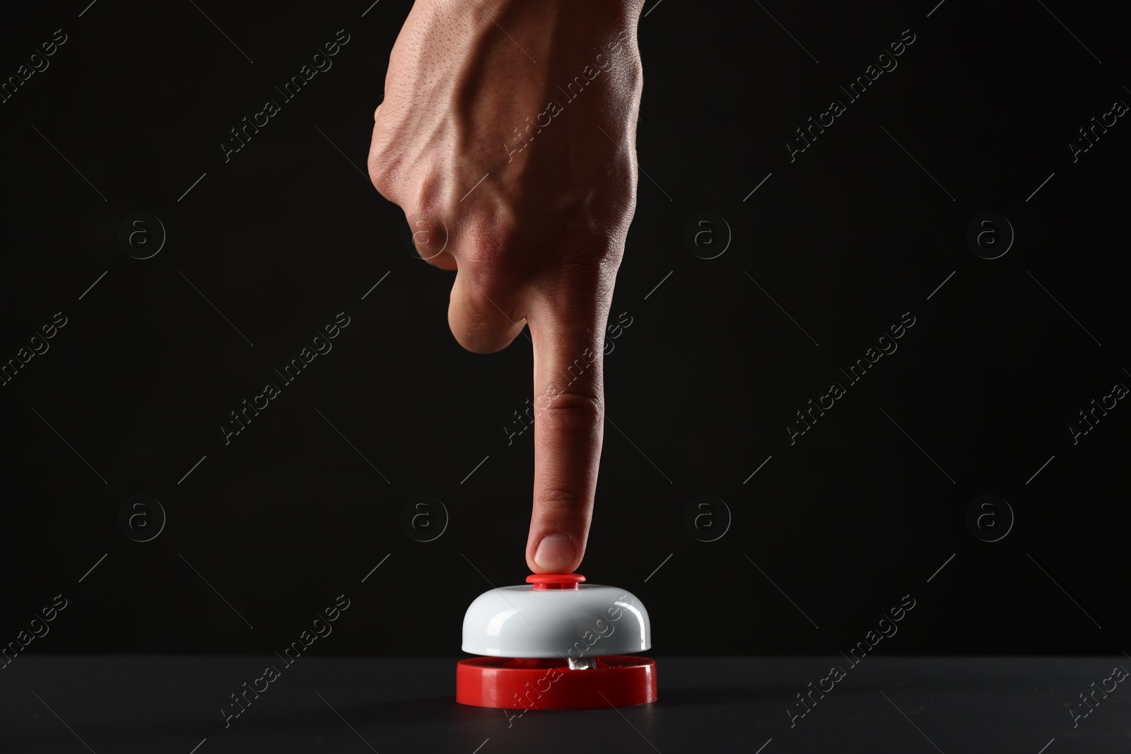 Man pressing button on black background, closeup Photo of Man pressing button on black background, closeup