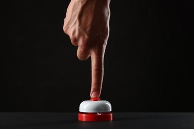 Photo of Man pressing button on black background, closeup