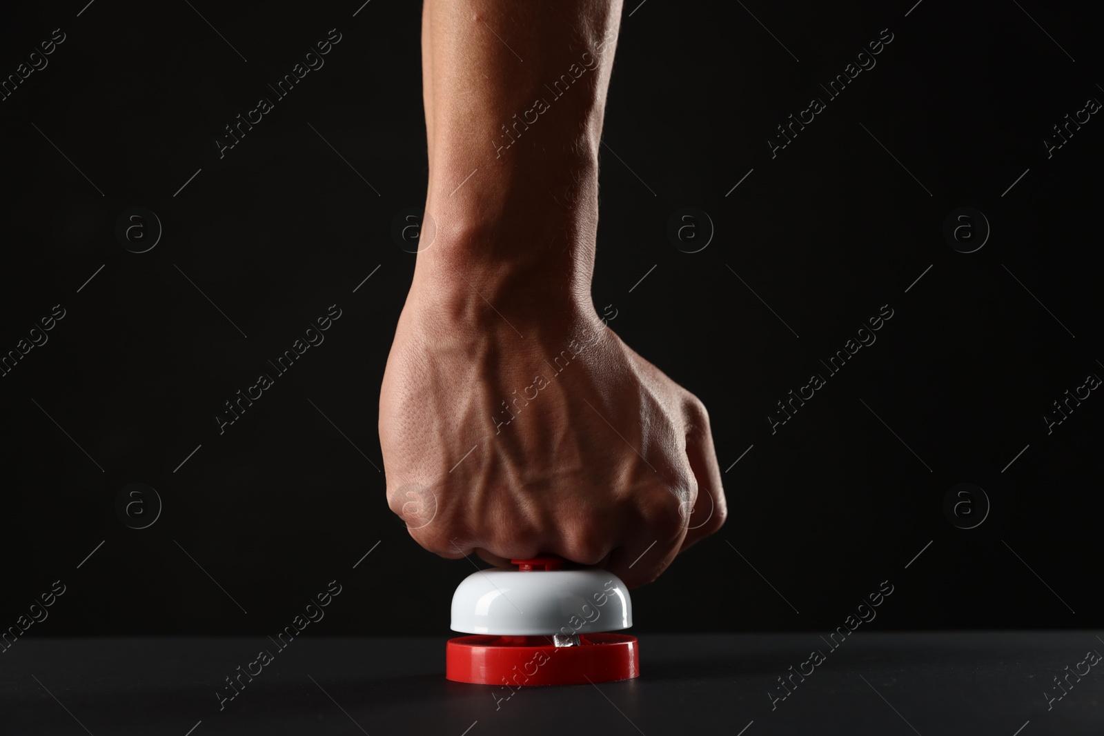 Man pressing button on black background, closeup Photo of Man pressing button on black background, closeup