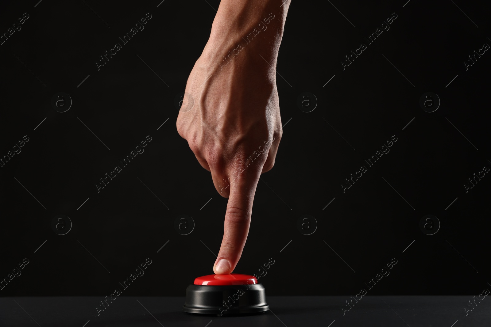 Man pressing button on black background, closeup Photo of Man pressing button on black background, closeup