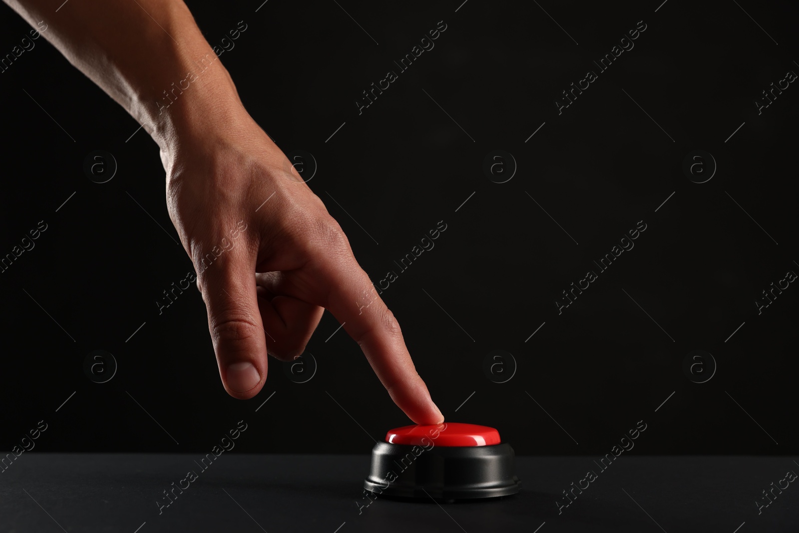 Man pressing button on black background, closeup. Space for text Photo of Man pressing button on black background, closeup. Space for text
