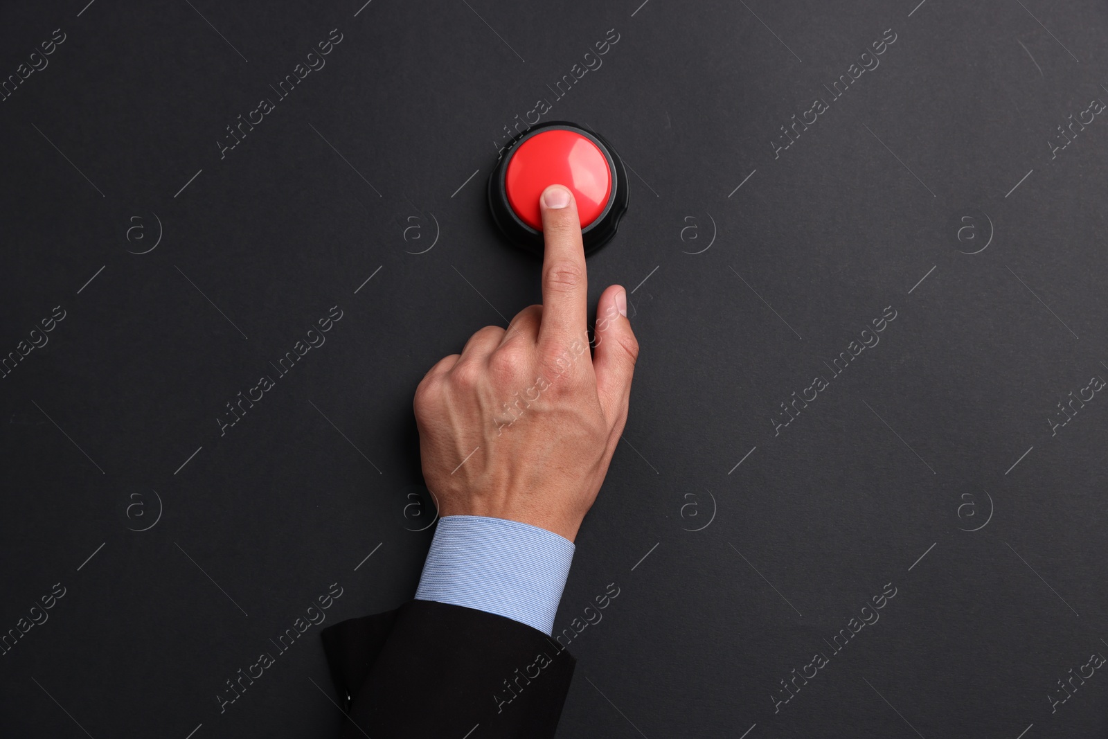 Man pressing button on black background, top view Photo of Man pressing button on black background, top view