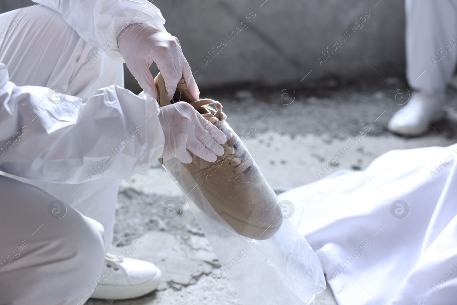 Forensic experts working at crime scene with dead body inside abandoned building, closeup Photo of Forensic experts working at crime scene with dead body inside abandoned building, closeup