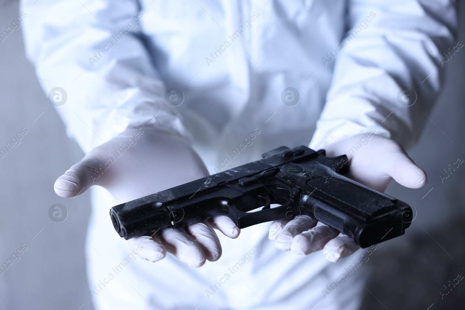 Forensic expert with evidence working at crime scene indoors, closeup Photo of Forensic expert with evidence working at crime scene indoors, closeup