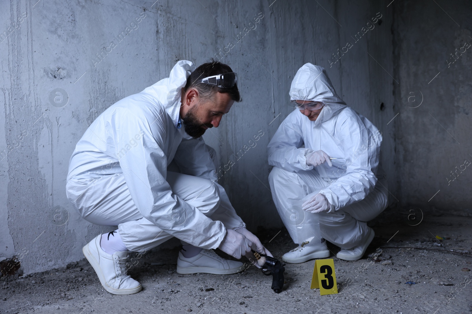 Forensic experts working at crime scene inside abandoned building Photo of Forensic experts working at crime scene inside abandoned building