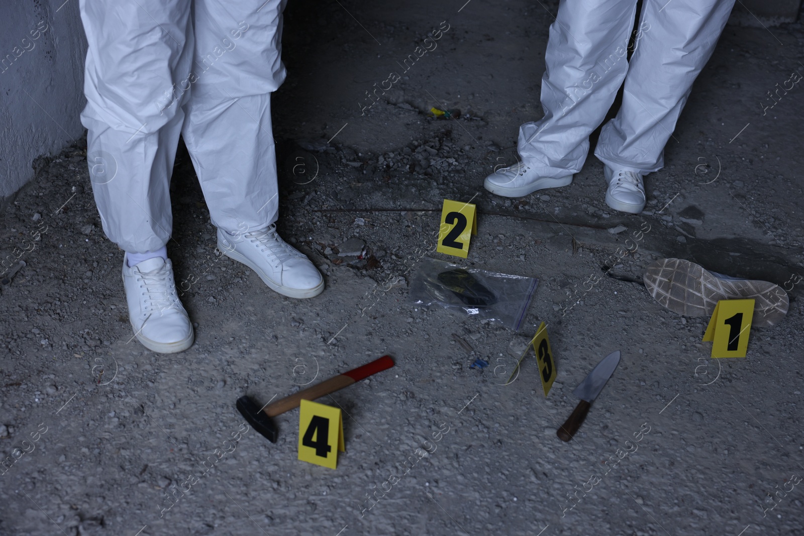 Forensic experts working at crime scene inside abandoned building, closeup Photo of Forensic experts working at crime scene inside abandoned building, closeup