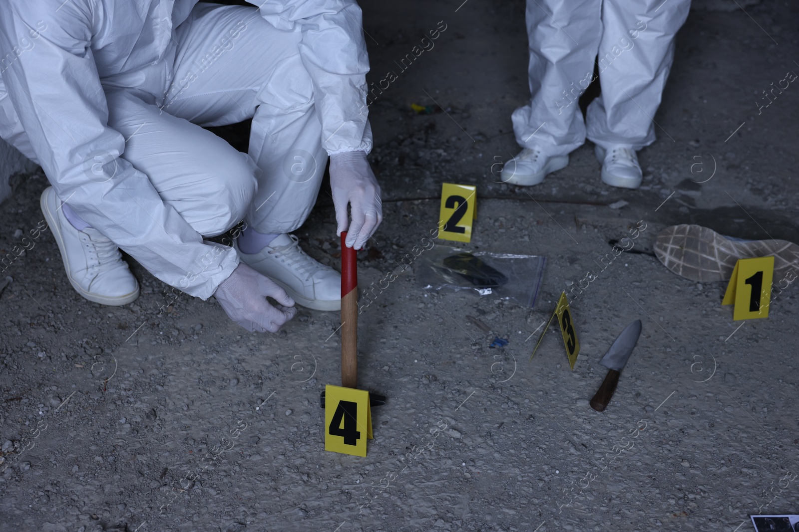 Forensic experts working at crime scene inside abandoned building, closeup Photo of Forensic experts working at crime scene inside abandoned building, closeup
